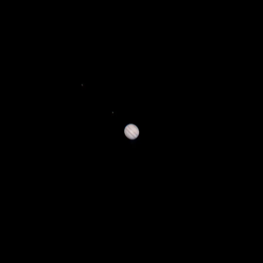 Jupiter with several Galilean moons visible