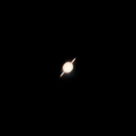 Saturn and its rings photographed through a Dobsonian telescope